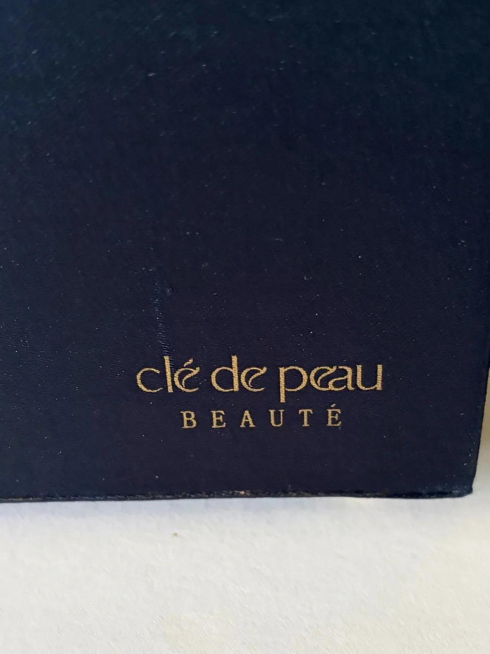 NWOT Cle’ de Peau elegant blue satin small/travel jewelry box. Mirror. Drawer